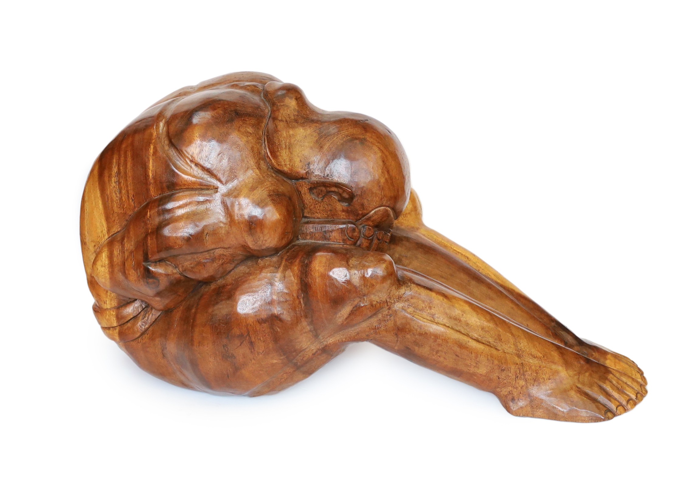 A Malaysian carved hardwood figure of the weeping Buddha, length 60cm. height 26cm